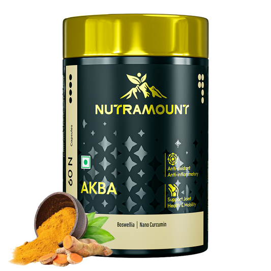 A black and gold bottle of Nutramount AKBA with Boswellia and Nano Curcumin, shown next to a small wooden bowl of turmeric powder and fresh turmeric root slices. The label features icons for anti-oxidant, anti-inflammatory, and joint health and mobility support.
