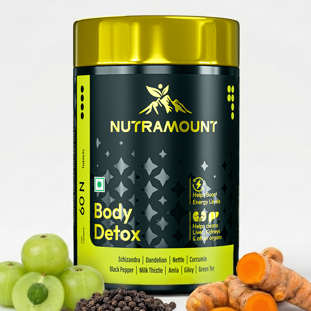 Nutramount Body Detox supplement bottle displayed alongside fresh amla, black pepper, and turmeric root to highlight its natural organ-cleansing ingredients.