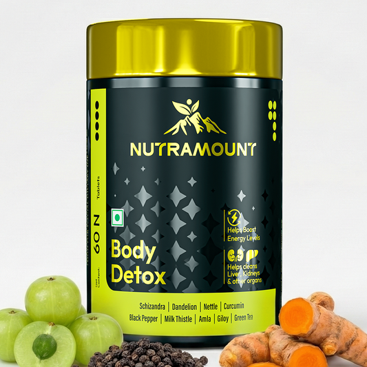 Nutramount Body Detox supplement bottle displayed alongside fresh amla, black pepper, and turmeric root to highlight its natural organ-cleansing ingredients.