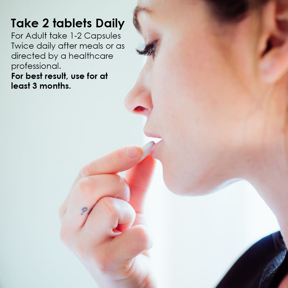 A hand holding a single supplement capsule, with text providing clear dosage instructions for adults to take 1-2 capsules twice daily, specifically recommending one capsule before breakfast and one before dinner.