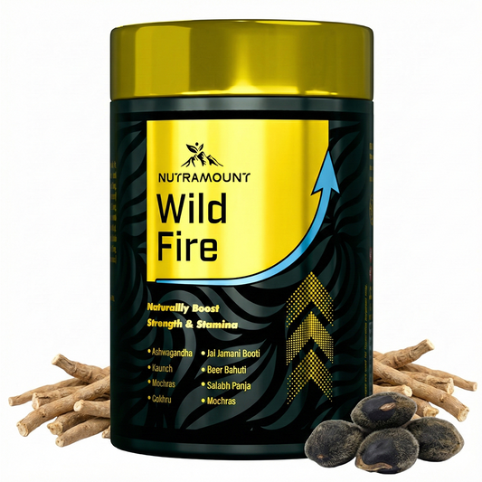 A container of "Nutramount Wild Fire" supplement featuring a gold lid and black label with yellow accents. The packaging highlights a formula for strength and stamina, surrounded by raw herbal roots and seeds.